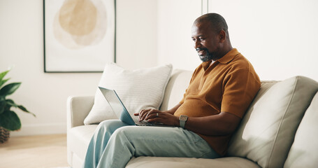 Laptop, typing and black man on couch with remote work, planning or creativity for copywriting...