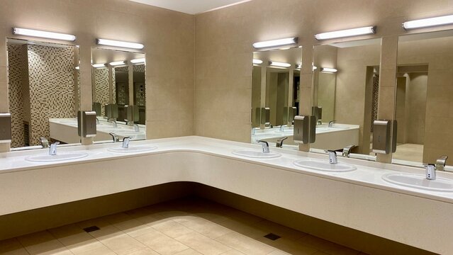 Clean spacious restroom vanity area inside modern commercial building.