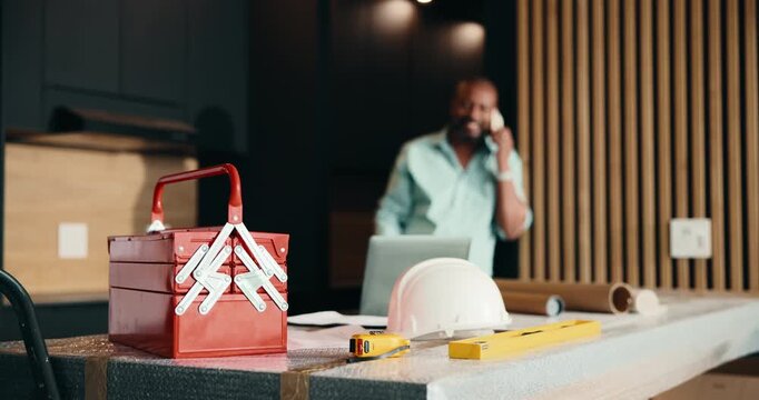 Maintenance, phone call and toolbox with black man in kitchen for home improvement or upgrade. Construction, renovation and service with mature contractor in modern apartment for building project