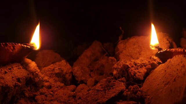 Traditional Clay Oil Lamps Diyas Burning with Glowing Flames in Darkness, Hindu Festival Diwali Celebration, Spiritual Prayer Light, Warm Candlelight, 4K Cinematic Stock Footage