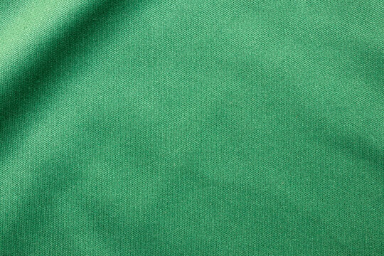 Green sports clothing fabric football shirt jersey texture close up