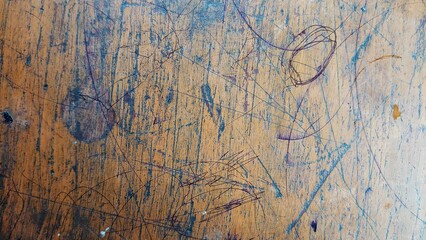 Scratched and scribbled old wooden school desk texture background © Atransz