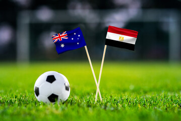 Obraz premium Australia vs Egypt, national flags before international football tournament Round of 32 match, football on green grass with goal in the background, Arlington, Texas, USA, July 3, 2026