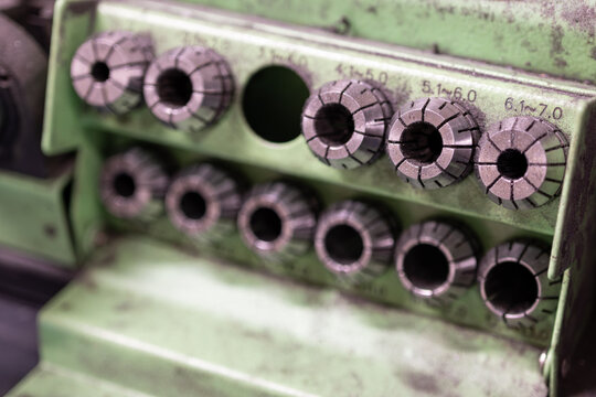 Detail of metal clamping reducers on a drill sharpener.