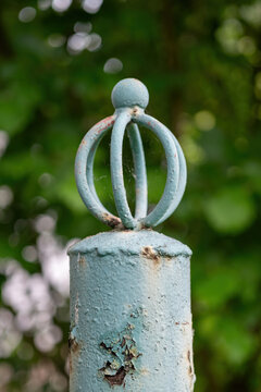 An old post with metal decoration outdoors.