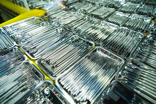Dental instruments arranged in metal trays.