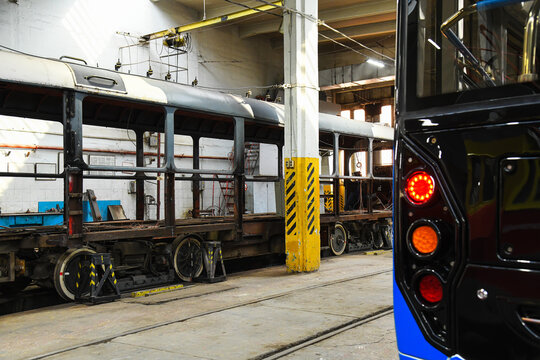 Modern tram in an industrial hall.