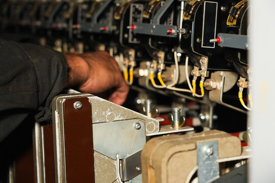 The hands that regulate the industrial electrical controls of an electric locomotive.