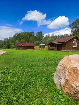 Traditional cottages in a green meadow.