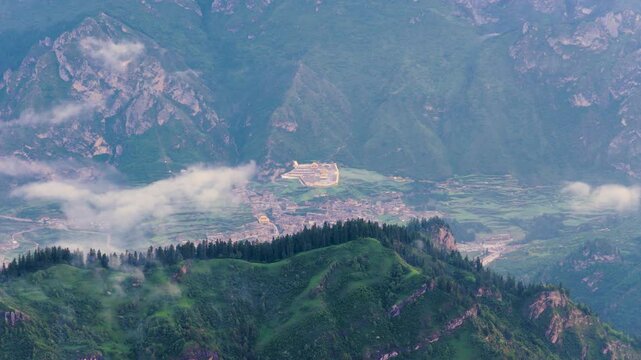 Panoramic view of Zhagana village in morning mist, Gannan Gansu, natural scenery of mountain valley with Tibetan settlements	
