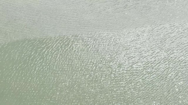 The shimmering surface of the river water. Ala Wai Canal, Honolulu, Oahu, Hawaii. The Ala Wai Canal is an artificial waterway which serves as the northern boundary of the tourist district of Waikiki. 