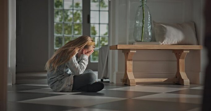 Sad, child and crying on floor in home for bullying victim, emotional distress and self isolation. Mental health, unhappy and girl with depression in house for trauma anxiety, abuse and overwhelmed