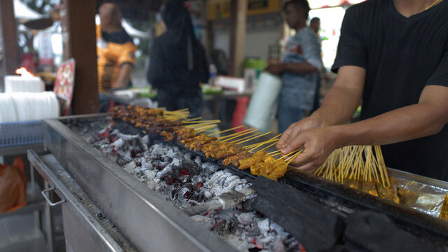 Vendor Grilling Meat Satay Skewers Over Hot Charcoal in Singapore