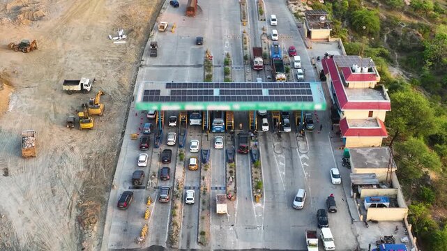 Aerial view of a busy fastag toll plaza with electronic payment lanes.