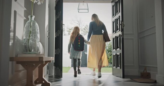 Doors, home and mother with child leaving for school and work in morning for commuting together. Bags, goodbye and back of mom walking with girl student for education and career in apartment.