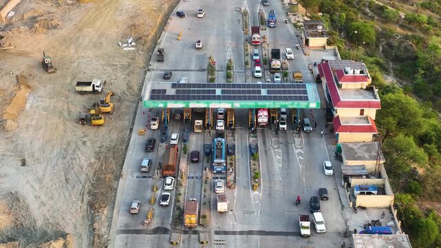 Drone shot of cars passing through modern automated Fast Tag toll collection booths.