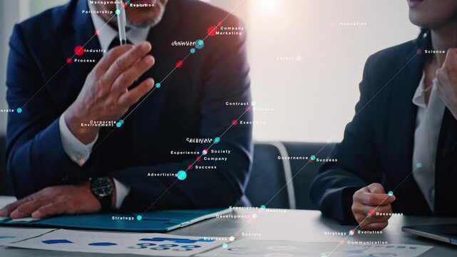 オフィスで会議するビジネスパーソンのグループとデジタルテクノロジーのコンセプト