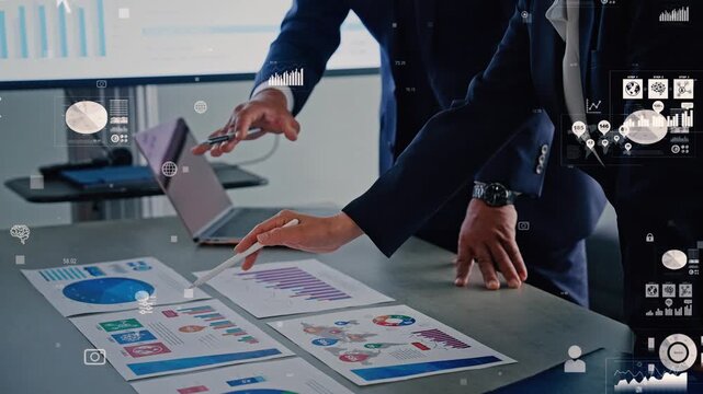 Concept of a group of business professionals holding a meeting in an office and digital data.