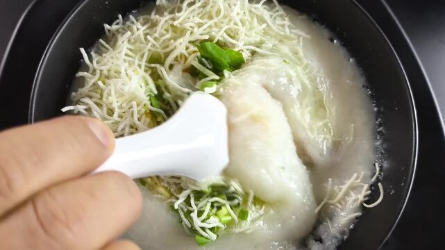 Closeup Pork congee with egg, ubdoor Chiangmai Thailand.