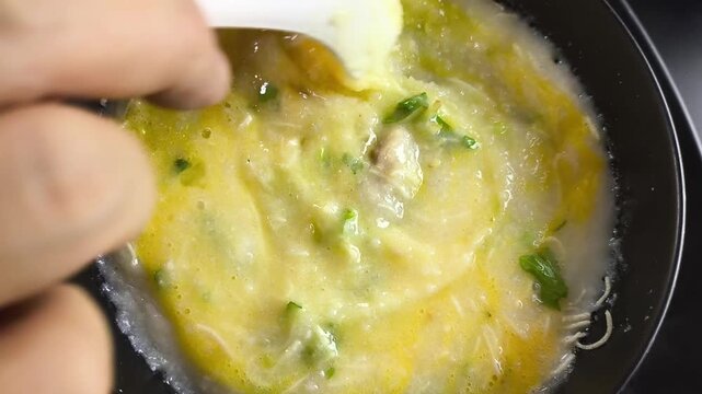 Closeup Pork congee with egg, ubdoor Chiangmai Thailand.