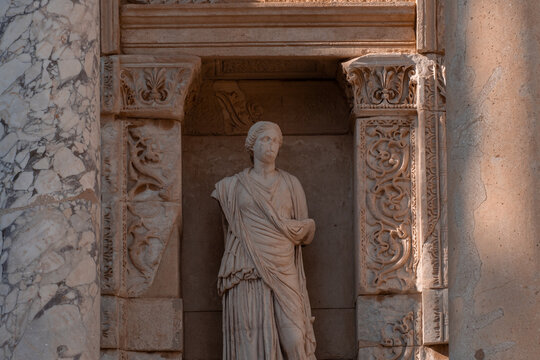 Ancient marble statues of virtues in the niches of the Celsus Library facade in Ephesus.