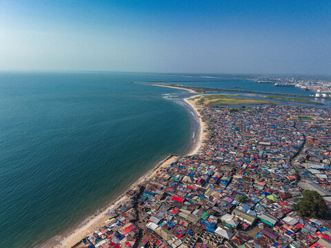 Aerial view of the dense urban landscape of Monrovia with colorful rooftops stretching along the sandy Atlantic coastline in Monrovia, Liberia.