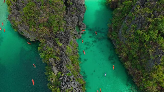 Aerial Top Down View of Big Lagoon Near Channel Dead End in El Nido, Philippines. Drone Birds-Eye Static Shot of Narrow Turquoise Waterway and Steep Limestone Cliff Walls.