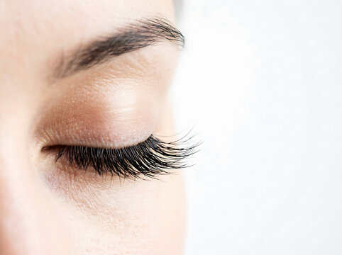 Close-up of a person's closed eye with long lashes