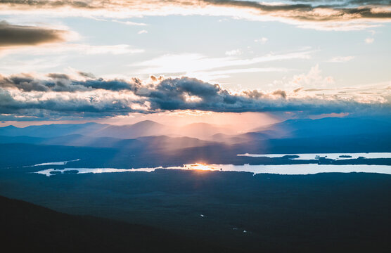 Sunlight breaking through clouds over Flagstaff Lake, Maine.