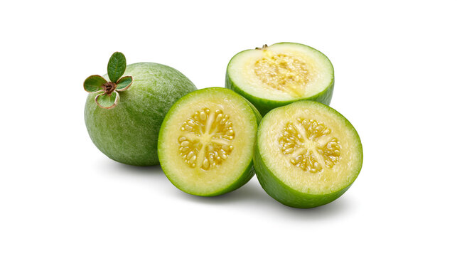 High-resolution studio shot of fresh green feijoas featuring a whole fruit and three halved pieces revealing juicy seed pulp, isolated on a clean white background
