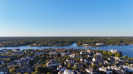 Aerial view of large mansion houses with swimming pool, in affluent neighborhood by Woodlands lake, Houston, Texas, expensive suburban homes surrounding by lush green trees, USA   © raeva