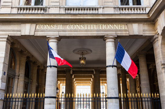 Paris, France - June 17, 2026: Low angle view of the portico decked with french flags at the entrance of the Constitutional Council, the highest constitutional authority, located in the Palais Royal.