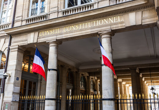 Paris, France - June 17, 2026: Portico decked with french flags at the entrance of the Constitutional Council, the highest constitutional authority in France, located in the Palais Royal.