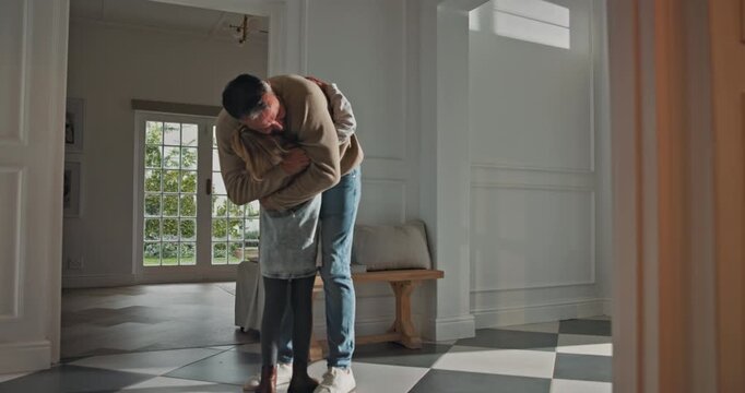 Father, child and hug in house with reunion, bonding together and love for family connection on weekend. Man, daughter and embrace in home entrance with reconciliation, wellness and care from parent.