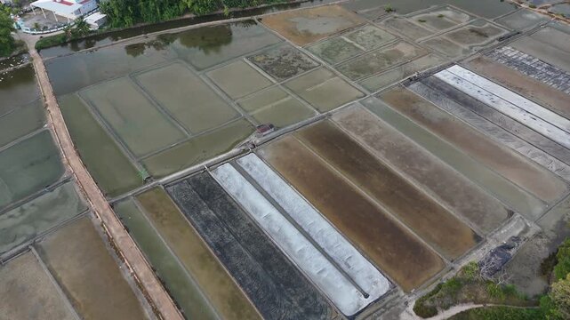 Aerial view of traditional salt evaporation ponds farm near the coastal area