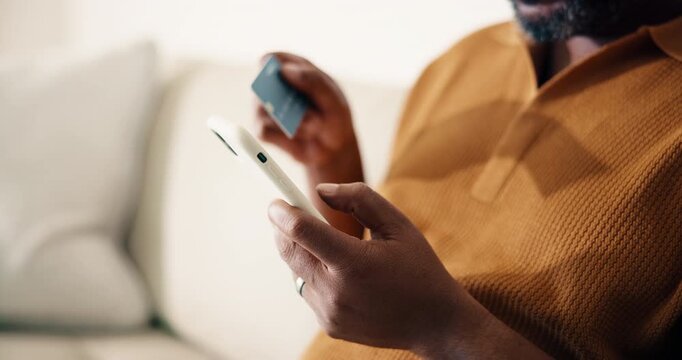 Man, hands and phone with credit card in home for online shopping, payment or banking app on sofa. Male person, shopper or smartphone with debit for mobile purchase, ecommerce or wireless transaction