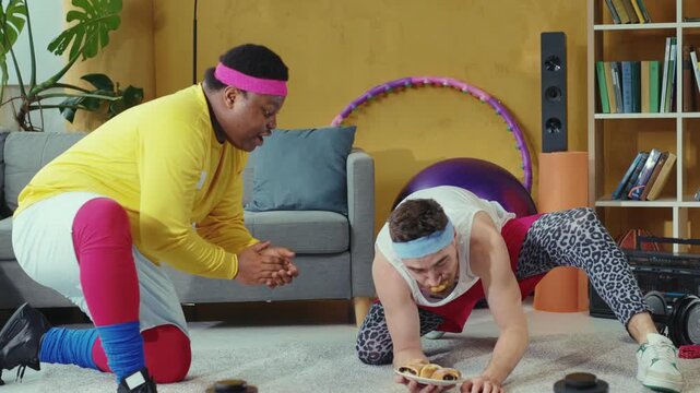 A man and a woman do pushups while another motivates them nearby