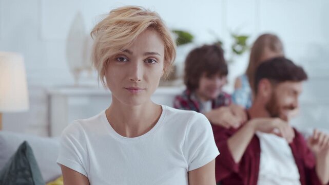 A woman converses warmly with family on a couch in a cozy room