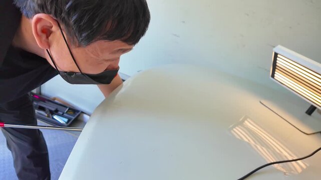 Removing dents on the car. PDR technology. Car body repair without painting.