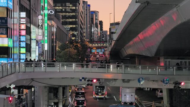 Twilight in Tokyo : Overlapping Urban Layers Composed by the Traffic Network as the Pedestrian Overpass Sits Between the Surface Street and the Elevated Highway  |  Shibuya Station Area, Tokyo, Japan