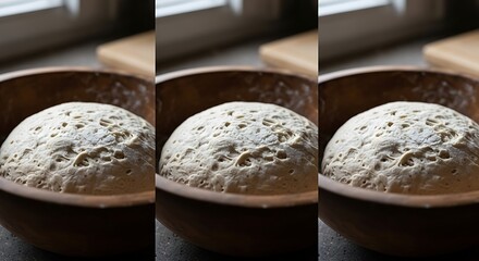 Fototapeta premium Fresh raw bread dough rising in a wooden bowl on a kitchen table