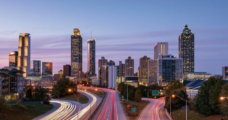 Naklejka premium Sunset illuminates Atlanta’s skyline, showcasing a lively urban environment with warm, inviting city lights.