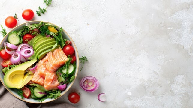 fresh salad bowl with avocado, salmon and vegetables on bright table