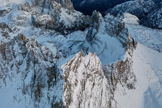 Aerial view of the snow-covered jagged peaks of Tre Cime di Lavaredo in the Dolomites, Auronzo di Cadore, Veneto, Italy.