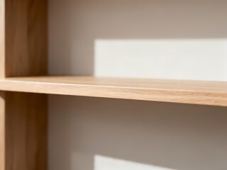 Fototapeta premium Minimalist Empty Wooden Shelves Against a Neutral Interior Wall with Soft Natural Sunlight and Sharp Shadows for Home Decor Display