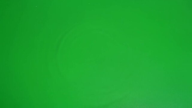 Abstract concentric green ripple pattern on seamless chroma key background
