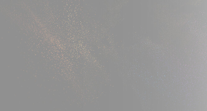 Golden sand particles on gray  background, glowing sparkle dust explosion split screen