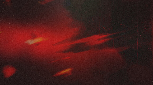 Film Grunge Background with Dark Red Light Leak, Warm Orange Streak, Heavy Film Grain, Scratch Lines and Distressed Texture Overlay on Black