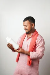 Happy indian farmer showing fertilizer  or pesticide bottle © PRASANNAPIX