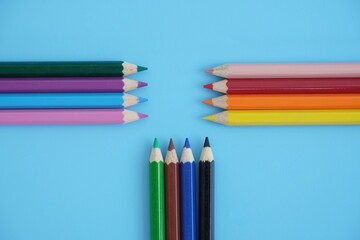 Fototapeta premium Colored pencils in various colors on a blue background
